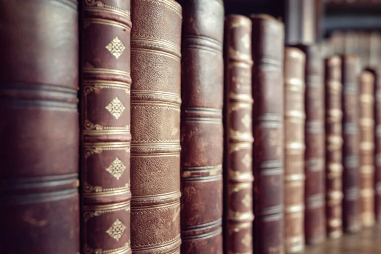 Old leather bound vintage books in a row education